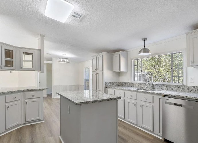 Gray semi-custom cabinets in a leased unit kitchen